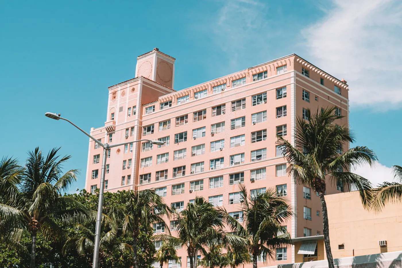 Art Deco apartment building behind palm trees